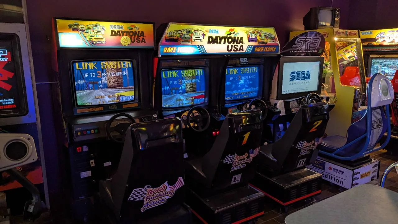 Three linked Daytona USA racing cabinets at Pixel Paradise Arcade in Angus